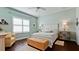 Cozy bedroom featuring hardwood floors, natural light, and a comfortable seating area at 1503 Calle Grand St, Bradenton, FL 34209