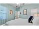 Comfortable bedroom showcasing a bed with a patterned comforter and soft blue walls at 1503 Calle Grand St, Bradenton, FL 34209
