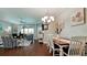 Inviting dining room with decorative chandelier and access to the spacious and comfortable living area at 1503 Calle Grand St, Bradenton, FL 34209