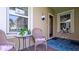 Charming front porch seating area, complete with a table and chairs for relaxation at 1503 Calle Grand St, Bradenton, FL 34209