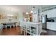Open concept kitchen with a granite countertop island, stainless steel appliances, and white cabinetry at 1503 Calle Grand St, Bradenton, FL 34209