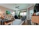 Comfortable living room with hardwood flooring, ceiling fan, and sliding glass doors leading to outdoor space at 1503 Calle Grand St, Bradenton, FL 34209