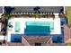 Aerial view of a rectangular pool with deck chairs and a spa at 1503 Calle Grand St, Bradenton, FL 34209