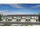 New townhome community showcasing multi-story units with attached garages and manicured lawns at 15184 Cuzcorro Ct, Nokomis, FL 34275