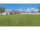 Large backyard with manicured lawn, white fence, storage shed, and solar panels on the house at 1606 22Nd W Ave, Palmetto, FL 34221