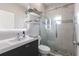 Modern bathroom features a glass shower with stone floor, a sleek vanity, and stylish shelving for an elegant touch at 1606 22Nd W Ave, Palmetto, FL 34221