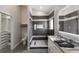 Modern bathroom showcases a sleek shower, double vanity, and spacious walk-in closet for ample storage at 1606 22Nd W Ave, Palmetto, FL 34221