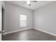 Neutrally decorated bedroom with hardwood floors, a ceiling fan, and a large window for lots of light at 1606 22Nd W Ave, Palmetto, FL 34221