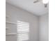 Bright bedroom with neutral walls features a window with blinds and modern ceiling fan at 1606 22Nd W Ave, Palmetto, FL 34221