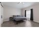 Simple bedroom with a comfortable bed, dark curtains, and stylish wood look flooring at 1606 22Nd W Ave, Palmetto, FL 34221
