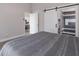 Bedroom boasts wood floors, barn door to ensuite bathroom, and seamless access to the kitchen at 1606 22Nd W Ave, Palmetto, FL 34221