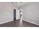 Spacious bedroom with wood-look floors featuring neutral walls and an open doorway to other rooms at 1606 22Nd W Ave, Palmetto, FL 34221