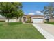 Charming single-story home with a well-manicured lawn, lush landscaping, and an attached two-car garage at 1606 22Nd W Ave, Palmetto, FL 34221