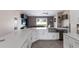 Open-concept kitchen with a large island, stainless steel sink, modern appliances, and a view into the living area at 1606 22Nd W Ave, Palmetto, FL 34221