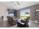 Bright living space with comfortable seating, an entertainment center, and sliding glass doors to the backyard at 1606 22Nd W Ave, Palmetto, FL 34221