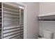 Spacious walk-in closet with custom shelves and ample space, next to a toilet and wall shelves at 1606 22Nd W Ave, Palmetto, FL 34221