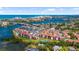 Expansive aerial view of waterfront condos, a tennis court, and beautiful blue waterways and beaches at 1624 Stickney Point Rd # 204, Sarasota, FL 34231