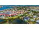 Scenic aerial view of waterfront condos highlighted by a tennis court, lush grass, and tranquil waterways at 1624 Stickney Point Rd # 204, Sarasota, FL 34231