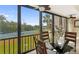 Dining area featuring a glass table and view of the tennis court, lush greenery, and water at 1624 Stickney Point Rd # 204, Sarasota, FL 34231