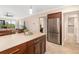 Bright and airy open concept; kitchen, living room and stainless fridge with adjacent bathroom at 1624 Stickney Point Rd # 204, Sarasota, FL 34231