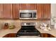 Close up of kitchen details including countertops, stainless appliances, and dark wood cabinetry at 1624 Stickney Point Rd # 204, Sarasota, FL 34231