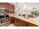 Open eat-in kitchen with stainless appliances and seamless flow to living room and balcony at 1624 Stickney Point Rd # 204, Sarasota, FL 34231