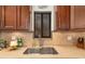 Kitchen sink featuring dark cabinetry, stone backsplash and view out of the window at 1624 Stickney Point Rd # 204, Sarasota, FL 34231