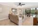 Cozy living room featuring comfortable seating, neutral tones, and access to a dining area and balcony at 1624 Stickney Point Rd # 204, Sarasota, FL 34231
