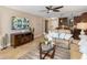 Comfortable living room with ceiling fan, flat screen TV and view into adjacent kitchen at 1624 Stickney Point Rd # 204, Sarasota, FL 34231