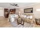 Spacious living room with plush couches, a glass coffee table, and a seamless transition to the kitchen at 1624 Stickney Point Rd # 204, Sarasota, FL 34231