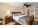 Comfortable bedroom features a king-sized bed, ceiling fan, and decorative wall art at 1624 Stickney Point Rd # 204, Sarasota, FL 34231