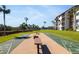 Shuffleboard court next to building, under palm trees with tables and seating nearby at 1624 Stickney Point Rd # 204, Sarasota, FL 34231