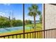 Scenic view of a community tennis court with lush landscaping, a walking path, and water views at 1624 Stickney Point Rd # 204, Sarasota, FL 34231