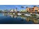 Colorful waterfront homes with docks and boats, reflecting on the calm blue water at 1624 Stickney Point Rd # 204, Sarasota, FL 34231