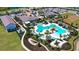 Stunning aerial view of the community pool and recreation center featuring multiple pools, cabanas and lush landscaping at 17119 Barnwood Pl, Bradenton, FL 34211