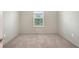 Well-lit bedroom with plush carpet, a large window, and neutral-toned walls for a calming atmosphere at 17119 Barnwood Pl, Bradenton, FL 34211
