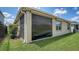 Exterior view of the property with roll-down hurricane shutters, green lawn, and well-maintained landscaping at 17119 Barnwood Pl, Bradenton, FL 34211