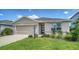 Charming one-story home featuring a stone-accented facade and a well-manicured lawn with lush landscaping at 17119 Barnwood Pl, Bradenton, FL 34211