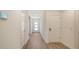 Bright hallway with wood-look floors and a smart thermostat for modern living at 17119 Barnwood Pl, Bradenton, FL 34211