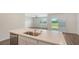 Bright kitchen with quartz countertops, stainless steel appliances, and an open view to the living area at 17119 Barnwood Pl, Bradenton, FL 34211