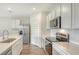 Bright kitchen featuring stainless steel appliances, white cabinets, subway tile backsplash, and quartz countertops at 17119 Barnwood Pl, Bradenton, FL 34211