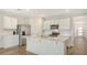 Bright kitchen with stainless steel appliances, white cabinets, and quartz countertops with a center island at 17119 Barnwood Pl, Bradenton, FL 34211