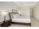 Bright bedroom featuring neutral colors, a tray ceiling, and tiled floors at 17449 Sandpearl Rd, Venice, FL 34293