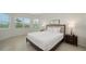 Bright bedroom showcasing natural light, neutral colors, and tiled floors at 17449 Sandpearl Rd, Venice, FL 34293