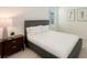 Cozy bedroom with a comfortable bed, bedside table, and stylish lamp at 17449 Sandpearl Rd, Venice, FL 34293