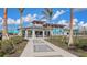 Community clubhouse featuring outdoor seating, lush landscaping, and modern design, perfect for social gatherings at 17449 Sandpearl Rd, Venice, FL 34293