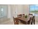 Cozy dining room area featuring a wooden table, seating for six, and natural light at 17449 Sandpearl Rd, Venice, FL 34293