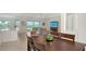 Bright dining room with modern light fixture, artwork, and a table with seating for six at 17449 Sandpearl Rd, Venice, FL 34293
