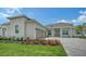 Charming home featuring a brick driveway, well-manicured lawn, attached two-car garage and beautiful landscaping at 17449 Sandpearl Rd, Venice, FL 34293