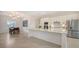 Spacious kitchen with stainless appliances, white cabinets, and adjacent dining area, perfect for entertaining at 17449 Sandpearl Rd, Venice, FL 34293